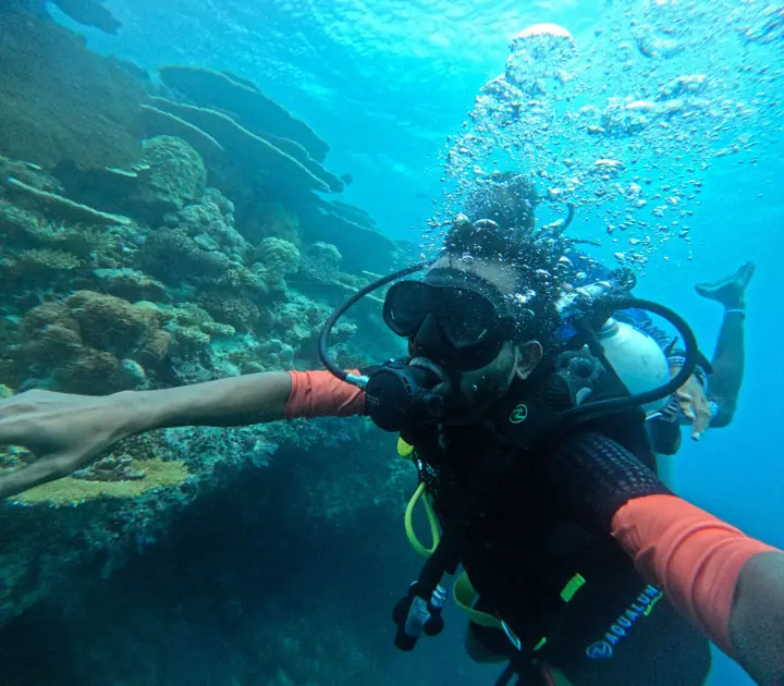 Scuba diver above a coral reef in the Maldives
