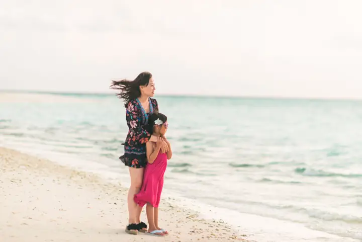 Mother and daughter on a white-sand Maldives beach