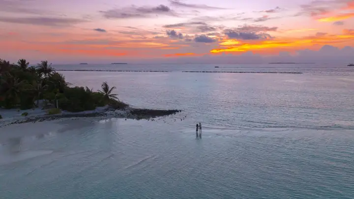 Sunset over a calm Maldives lagoon